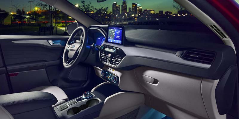 Car interior at night with city skyline