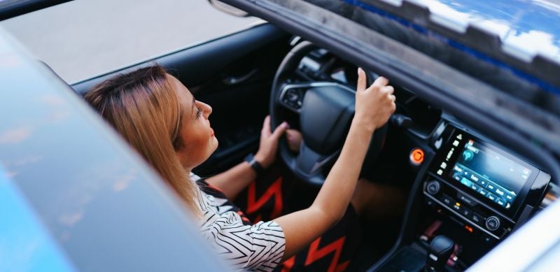 Woman driving around Huntersville With a Working Sunroof